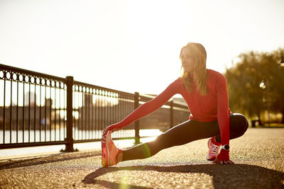 A woman stretching before her run in a city park.