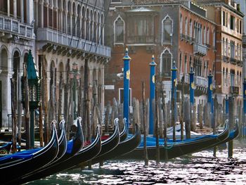 View of gondolas moored in canal of venice 