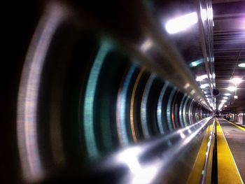 Illuminated tunnel at night