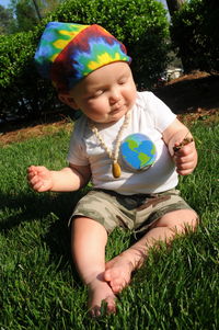 Baby girl holding grass