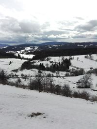 Scenic view of frozen lake against sky during winter