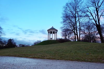 Built structure on field against sky