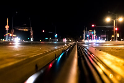 Illuminated road in city at night