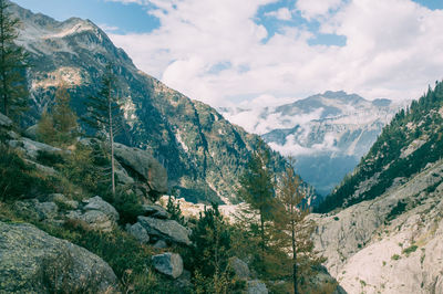 Scenic view of mountains against cloudy sky