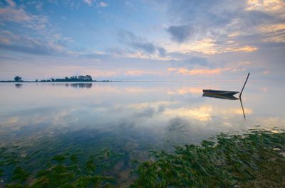 Scenic view of lake against sky during sunset