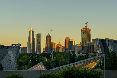 Buildings in city against sky during sunset