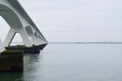 Bridge over river against sky