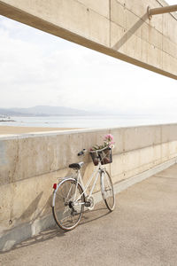 Bicycle with flowers by wall