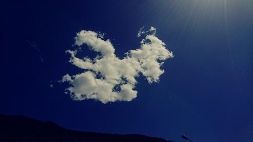 Low angle view of mountain against blue sky