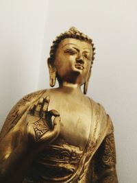 Low angle view of statue against wall