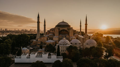 Panoramic view of buildings in city against sky during sunset