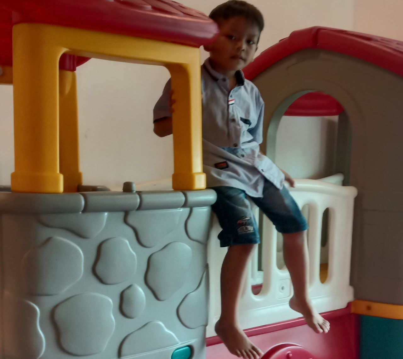 FULL LENGTH OF BOY SITTING ON SEAT IN HOME