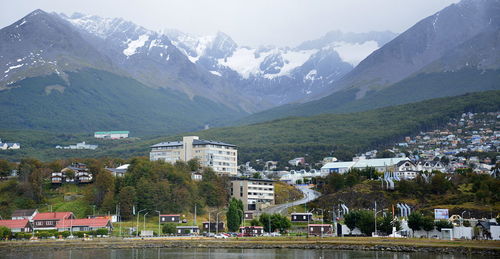 Scenic view of residential district and mountains against sky