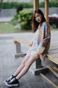 Portrait of young woman standing on street