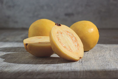 Yellow guava on wooden background. vitamin c, healthy fruit diet.