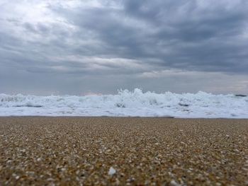 Surface level of beach against sky