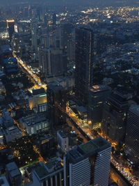 High angle view of illuminated buildings in city at night