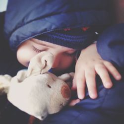 Close-up of cute boy sleeping with stuffed toy
