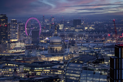 Illuminated cityscape against sky at night