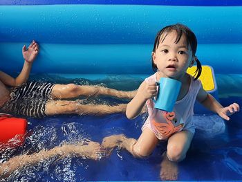 High angle view of girl playing in pool