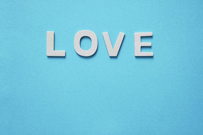 Close-up of text on blue wall