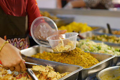 Midsection of man preparing food on table