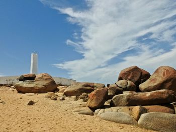 Lighthouse rocks on sand