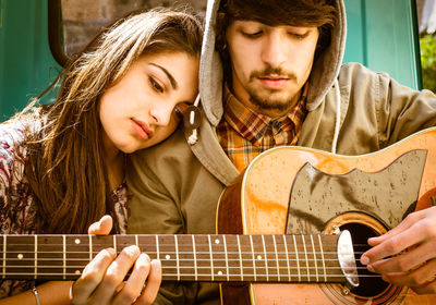 Portrait of a young man playing guitar