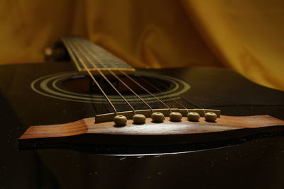 Close-up of guitar on fabric