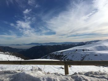 Snow covered landscape against mountain range