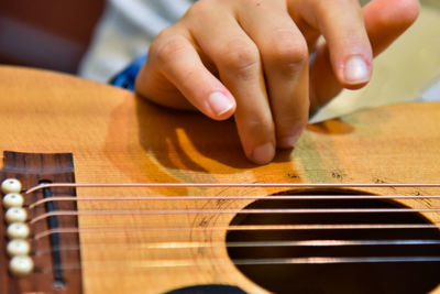 Close-up of hands playing guitar