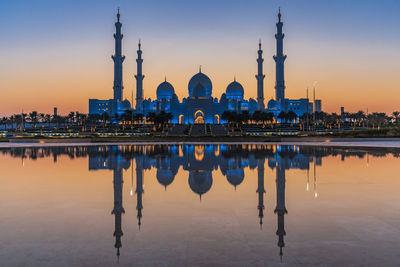 Reflection of temple in water at sunset