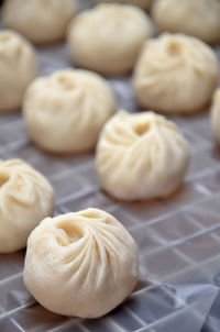 Close-up of fresh homemade chinese dumplings on wax paper