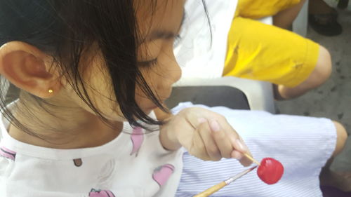 Girl painting lollipop