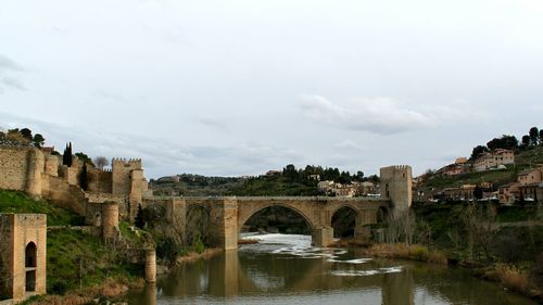 Bridge over river with buildings in background