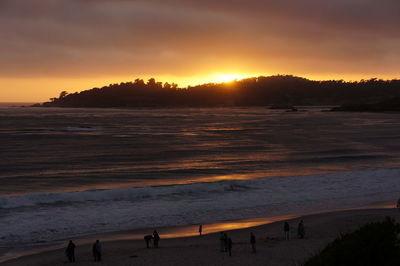 Scenic view of beach against sky during sunset