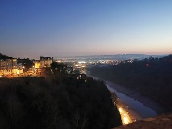 High angle view of illuminated buildings against sky at night