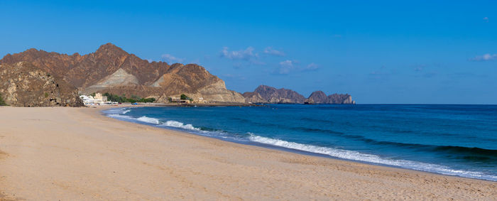 Scenic view of beach against blue sky