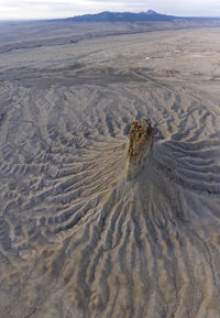 Erosion cuts deep lines in the earth surround the chimney rock m