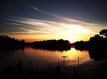 Scenic view of sunset over lake