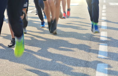 Low section of people walking on street