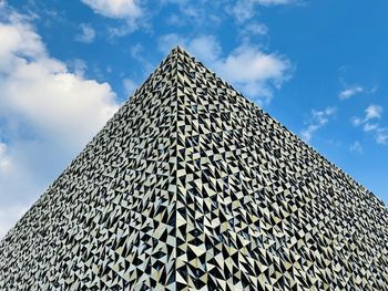 Low angle shot from ground. view of building corner against blue sky