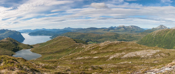 Scenic view of mountains against cloudy sky