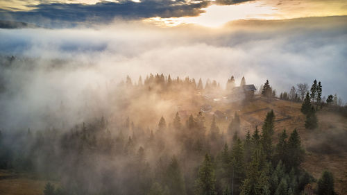 Alpine village. autumn rural landscape. cold november morning. morning fog in mountain valley. 