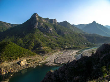 Scenic view of river amidst mountains against clear sky