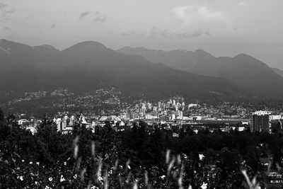 High angle view of townscape and mountains against sky