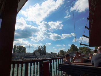 Boy by railing against sky