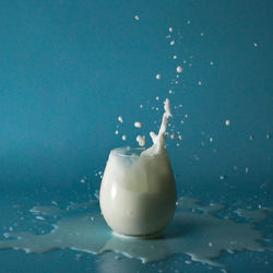 Close-up of drink in water against blue background