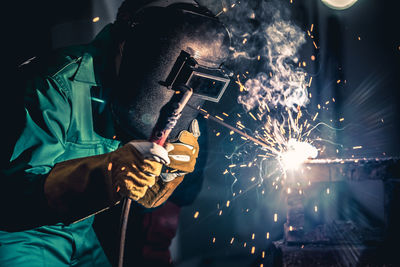 Midsection of man working at night