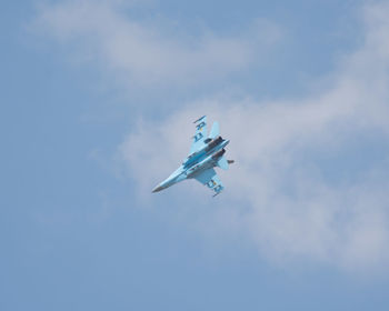 Low angle view of airplane flying in sky